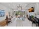 Bright living room with fireplace, piano, large windows, and comfortable seating at 19117 Davidson Concord Rd, Davidson, NC 28036