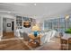 Comfortable living room with built-in bookshelves, a cozy sofa, and large windows overlooking the yard at 19117 Davidson Concord Rd, Davidson, NC 28036