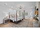 Spacious main bedroom with a four-poster bed, hardwood floors, and an ensuite bathroom at 19117 Davidson Concord Rd, Davidson, NC 28036