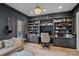 A modern office with custom built-in shelves and dark gray walls at 19117 Davidson Concord Rd, Davidson, NC 28036