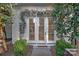 Charming patio entrance with lush greenery and stylish shuttered glass doors at 19117 Davidson Concord Rd, Davidson, NC 28036