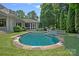 Backyard pool featuring lush landscaping, a stone patio, and a charming waterfall feature at 19117 Davidson Concord Rd, Davidson, NC 28036
