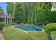 Backyard oasis with a pristine pool, hot tub, and lush landscaping for ultimate relaxation at 19117 Davidson Concord Rd, Davidson, NC 28036