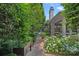 Charming brick pathway leading to the home with lush landscaping and manicured shrubbery at 19117 Davidson Concord Rd, Davidson, NC 28036