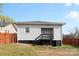 Cozy home featuring white horizontal siding, painted foundation, and covered porch with access stairs in the backyard at 200 N Martin Luther King Jr N Ave, Salisbury, NC 28144