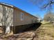 Exterior view of home featuring a brick foundation and vinyl siding at 201 E Boston Ave, Bessemer City, NC 28016