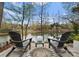 Relaxing backyard with a fire pit, comfortable seating, and picturesque lake views beyond at 21311 Baltic Dr, Cornelius, NC 28031