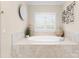 Soaking tub with tile surround under window with shutter at 21311 Baltic Dr, Cornelius, NC 28031