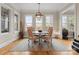 Bright dining area featuring modern lighting fixture, wood floors and large windows for natural light at 21311 Baltic Dr, Cornelius, NC 28031