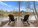 Inviting lake view from wooden dock with two Adirondack chairs at 21311 Baltic Dr, Cornelius, NC 28031