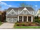 Charming two-story home with gray siding, white trim, columns, and a two-car garage at 21311 Baltic Dr, Cornelius, NC 28031