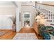 Bright foyer with hardwood floors, staircase, white railing, and view to the living room at 21311 Baltic Dr, Cornelius, NC 28031