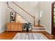 Inviting foyer with hardwood floors, staircase, stylish decor, and a round window at 21311 Baltic Dr, Cornelius, NC 28031
