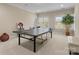 Spacious game room with a ping pong table, a large plant, and several windows at 21311 Baltic Dr, Cornelius, NC 28031