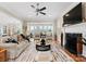 Bright living room featuring a fireplace, large windows, and modern decor at 21311 Baltic Dr, Cornelius, NC 28031