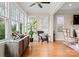 Light-filled living room featuring large windows with shutters, modern decor, and hardwood floors at 21311 Baltic Dr, Cornelius, NC 28031