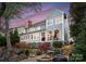 Back of a two-story grey home with a patio set with a firepit and a grill at 21311 Baltic Dr, Cornelius, NC 28031