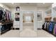 Massive walk-in closet with custom shelves leading to a bathroom at 21311 Baltic Dr, Cornelius, NC 28031
