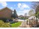 Expansive backyard showcasing a sparkling pool, greenhouse, and meticulous landscaping at 2508 Shaggy Bark Ct, Belmont, NC 28012