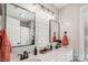 Bright bathroom with double vanity sinks, modern fixtures, and a large mirror providing ample space and functionality at 2508 Shaggy Bark Ct, Belmont, NC 28012