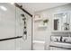 Bright bathroom featuring a glass shower with a matte black shower head and white shelves with decor at 2508 Shaggy Bark Ct, Belmont, NC 28012