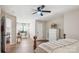 Inviting bedroom features wood floors, a ceiling fan, a white dresser, and a vanity with plants at 2508 Shaggy Bark Ct, Belmont, NC 28012
