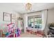 Bright bedroom with a play area, ample natural light, and a view of the pool creating a fun and inviting space at 2508 Shaggy Bark Ct, Belmont, NC 28012