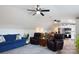 Upstairs living room and kitchen featuring comfortable seating, a ceiling fan, and an open kitchen creating a functional space at 2508 Shaggy Bark Ct, Belmont, NC 28012