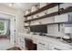 Home office space with custom built-ins, a marble countertop, and a comfortable chair creating a functional and stylish workspace at 2508 Shaggy Bark Ct, Belmont, NC 28012