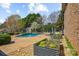 Inviting backyard pool area featuring lush landscaping and a charming outdoor shed at 2508 Shaggy Bark Ct, Belmont, NC 28012