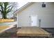 Home's back exterior featuring a wooden deck and white door at 257 3Rd Se Ave, Hickory, NC 28602