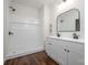 Modern bathroom with dual vanity, white subway tile shower, and wood-look flooring at 257 3Rd Se Ave, Hickory, NC 28602