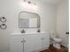 Bathroom with dual sinks, granite countertops, modern black fixtures and wood-look flooring at 257 3Rd Se Ave, Hickory, NC 28602