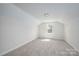 Bright bedroom featuring neutral walls, plush carpet, and a window at 257 3Rd Se Ave, Hickory, NC 28602