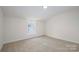 Cozy bedroom featuring neutral walls, plush carpet, and a bright window at 257 3Rd Se Ave, Hickory, NC 28602