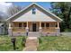 Charming home featuring a welcoming front porch with railings and a well-manicured lawn at 257 3Rd Se Ave, Hickory, NC 28602