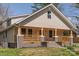 Attractive home featuring a cozy front porch with beautiful wood accents and a manicured lawn at 257 3Rd Se Ave, Hickory, NC 28602