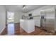 Bright kitchen features white cabinets, stainless steel appliances, granite countertops, and a center island at 257 3Rd Se Ave, Hickory, NC 28602
