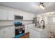Modern kitchen featuring stainless steel appliances, white cabinets, and a center island with granite countertops at 257 3Rd Se Ave, Hickory, NC 28602