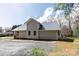 A view of the house featuring a metal roof and ample yard space, surrounded by trees at 257 3Rd Se Ave, Hickory, NC 28602