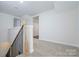 Staircase with carpeted steps and modern black metal railing and wood banister at 257 3Rd Se Ave, Hickory, NC 28602
