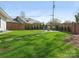Landscaped backyard with manicured lawn, stepping stone path, and inviting firepit area at 3301 Mountainbrook Rd, Charlotte, NC 28210