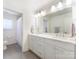 Bright bathroom with double vanity, marble countertops, and tile floors at 3301 Mountainbrook Rd, Charlotte, NC 28210