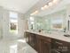 Elegant bathroom with dual sink vanity, marble countertops, and natural light from a large window at 3301 Mountainbrook Rd, Charlotte, NC 28210