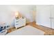 Well-lit bedroom with hardwood floors, white walls, a modern dresser, and ample space at 3301 Mountainbrook Rd, Charlotte, NC 28210