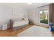 Bright bedroom featuring a daybed, hardwood floors, neutral walls, and natural light at 3301 Mountainbrook Rd, Charlotte, NC 28210