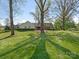 Spacious front yard with mature trees, offering shade and curb appeal to the property at 3301 Mountainbrook Rd, Charlotte, NC 28210