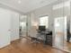 Bright home office with hardwood floors, built-in mirrored closet, and large window at 3301 Mountainbrook Rd, Charlotte, NC 28210