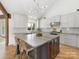 Open kitchen features a large island with bar seating, stainless appliances, and modern white cabinetry at 3301 Mountainbrook Rd, Charlotte, NC 28210