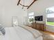 Cozy main bedroom features high ceilings, wood beams, modern decor, and ample natural light at 3301 Mountainbrook Rd, Charlotte, NC 28210